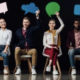 Team of professionals holding speech bubbles, representing seamless communication facilitated by a vCIO through a managed service provider in Dallas.